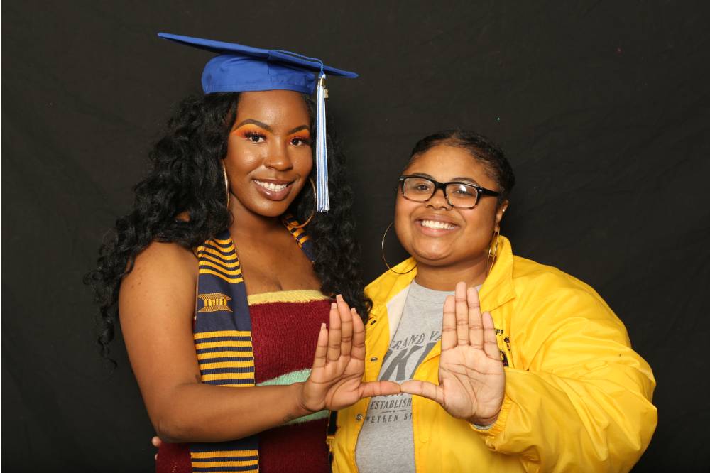 two students do sorority sign
